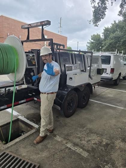 Our plumber in a reflective vest running the sewer camera