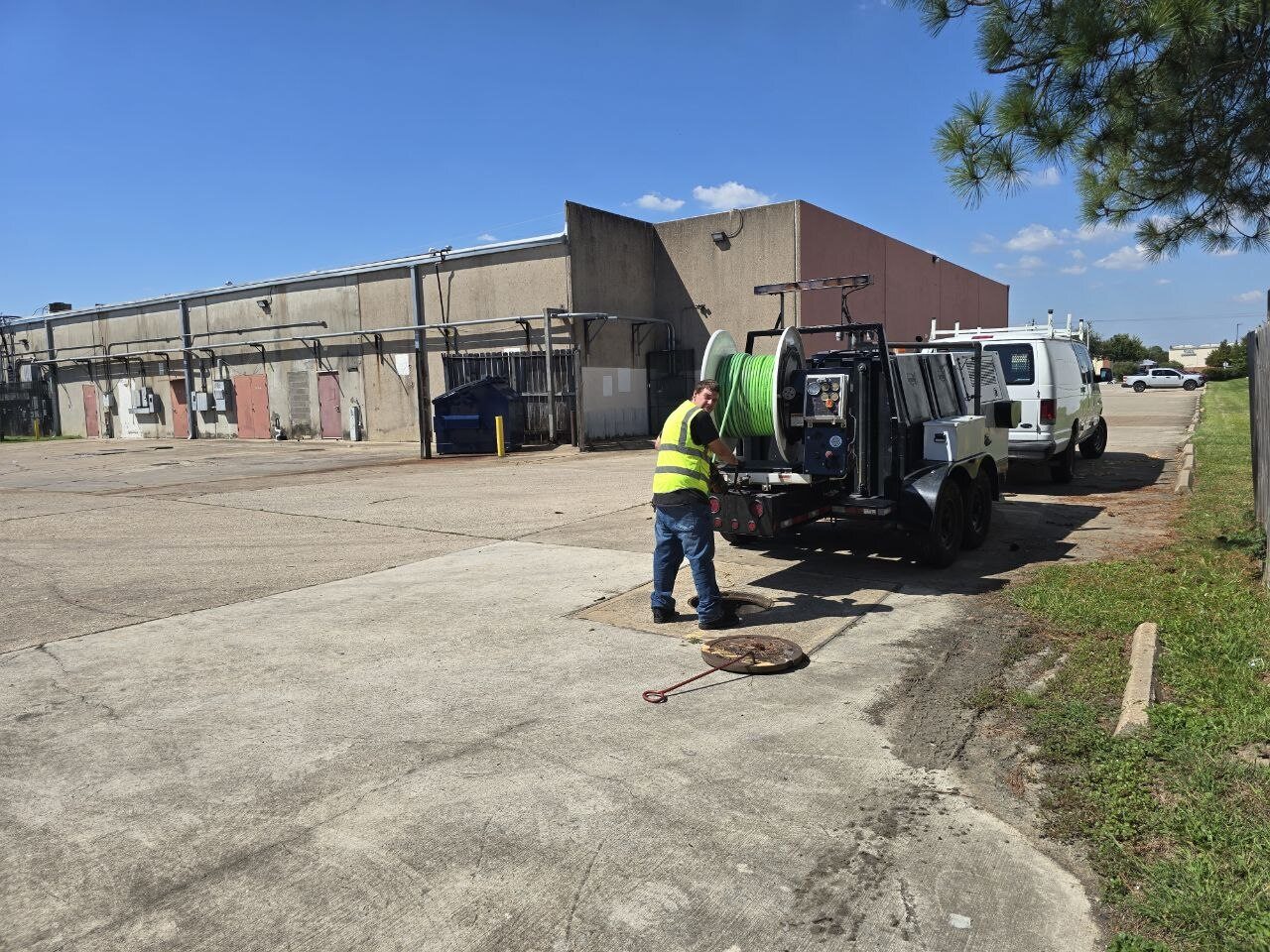 Wide view of the hydro-jetting setup on a commercial site